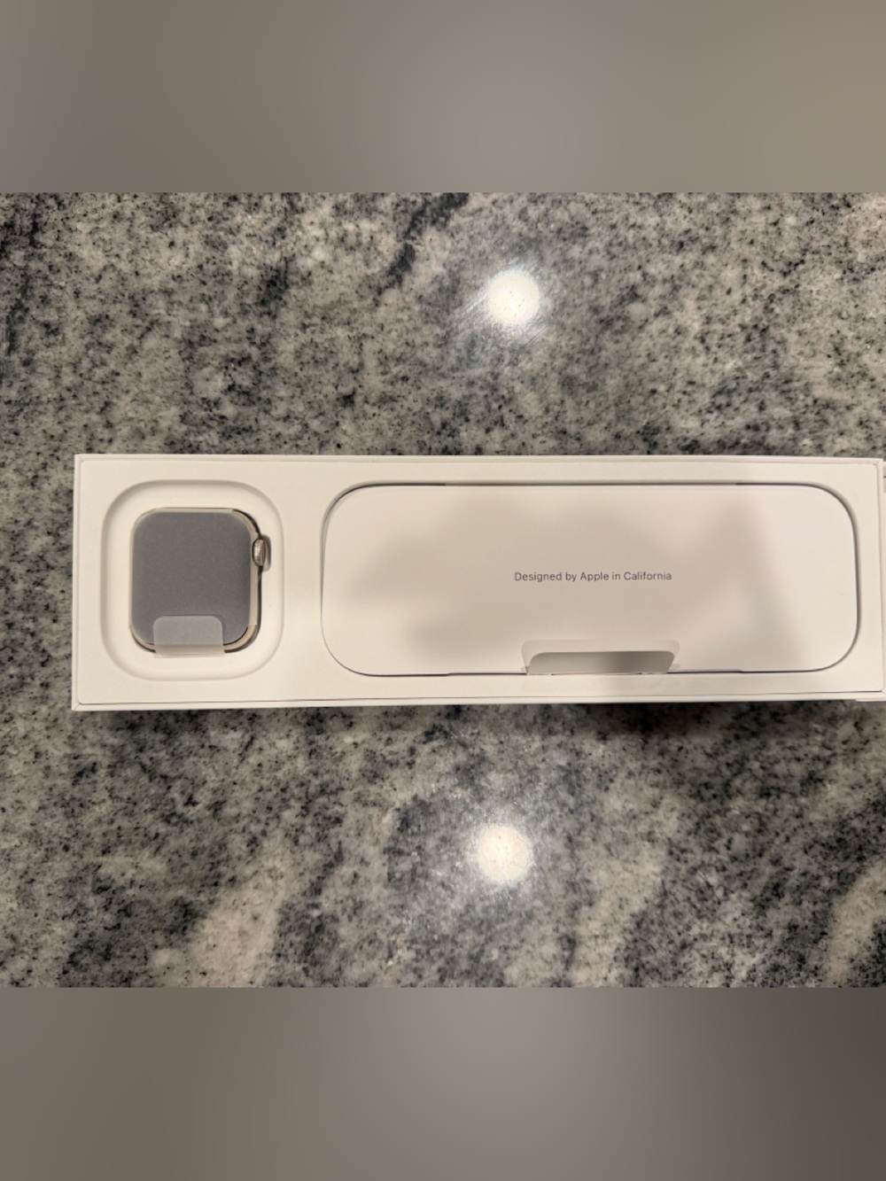 Apple Watch with Silver Case and Cream Packaging Insert